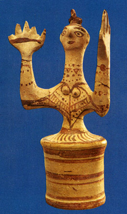 clay figurine with upraised arms and bell skirt