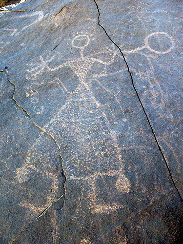 female figure holding hand drum, possibly