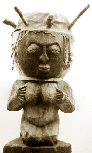 drum carved as a woman holding her breasts