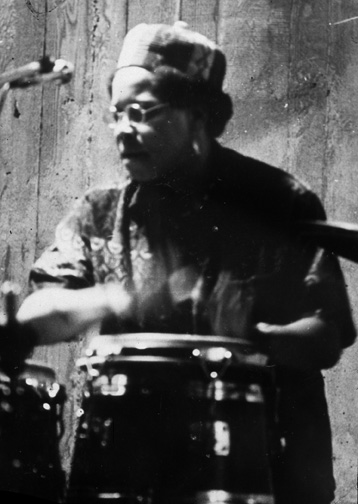 woman drummer in African cap